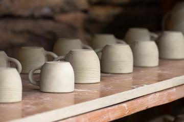 Set of clay pots.  Pottery workshop. Pottery handmade. Exhibition and sale of ceramic mugs 	