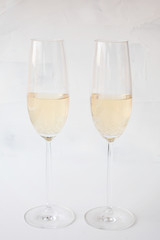 glasses  champagne on a white textured background