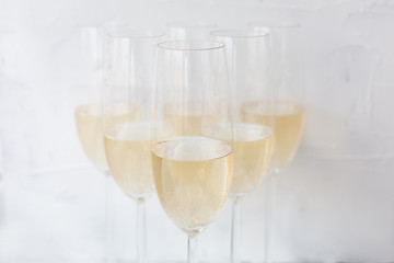 champagne glasses on white textured background