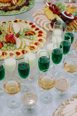 Festive table with cold exotic alcoholic beverages, cocktails and fruits. Celebration or other event