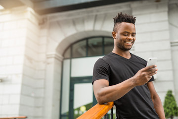 handsome young african man with a phone in his hand