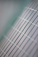 New green mesh fence, macro photo, selective art focus