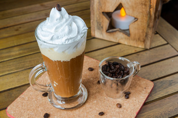 Mocaccino Coffee, Cup of Coffee with Cream and coffee grains. Cozy coffee