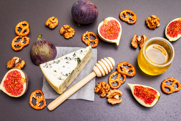 Cheese appetizer selection or wine snack set. Blue cheese, figs, honey, walnuts, pretzels