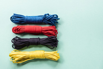 Colorful paracord isolated on turquoise background.