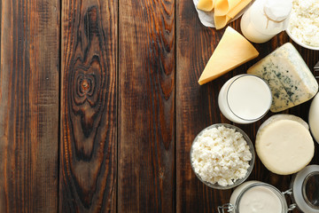 Fototapeta na wymiar Flat lay. Different dairy products on wooden background, copy space