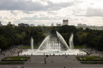 Fototapeta premium Panoramic view of the Gorky Park with a fountain and flowerbeds cloud on a summer day