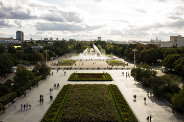 Panoramic view of the Gorky Park with a fountain and flowerbeds cloud on a summer day