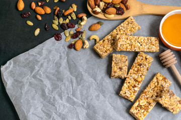 Obraz na płótnie Canvas Healthy homemade granola cereal bars with nuts, dried fruits and honey