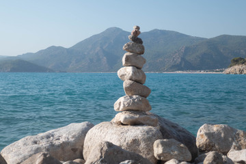 Fototapeta na wymiar Pyramid of stones on beach