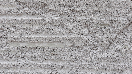 Light concrete blocks closeup texture. Tripophobia. Many small holes of gray colored stone.