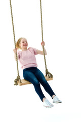 Beautiful teen school girl swinging on a swing. Concept summer v