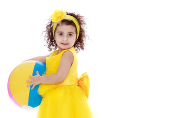 Little girl is playing with a ball.The concept of children's spo