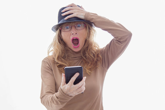 senior adult woman with mobile phone and surprise expression isolated on white background