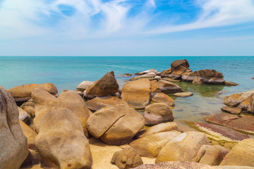 Big yellow rocks in the sea against the blue sky. Thailand. Samui. Gulf of Thailand. Lamai beach