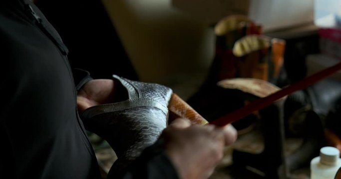 Woman Shoemaker making a par of shoes