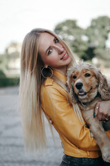 Young girl with dog walks in the park and enjoys the beautiful summer day.