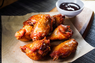 Juicy hot grilled chicken wings with barbecue sauce close-up