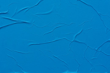 Blue crumpled sheet of paper close-up.