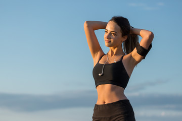 A young slim athletic girl in sportswear with snakeskin prints performs a set of exercises. Fitness and healthy lifestyle.	