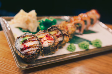 Sushi Warm Ebi Sake Unagi Spring plateau buffet in night dining restaurant flat lay. Delicious Smoked salmon rolls flesh seaweed and ginger. The norwegian salmon and Fish.
