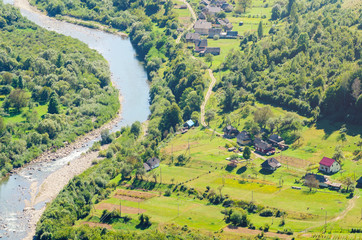 Ukraine Carpathians, a settlement in a valley of mountains, beautiful landscape aerial view