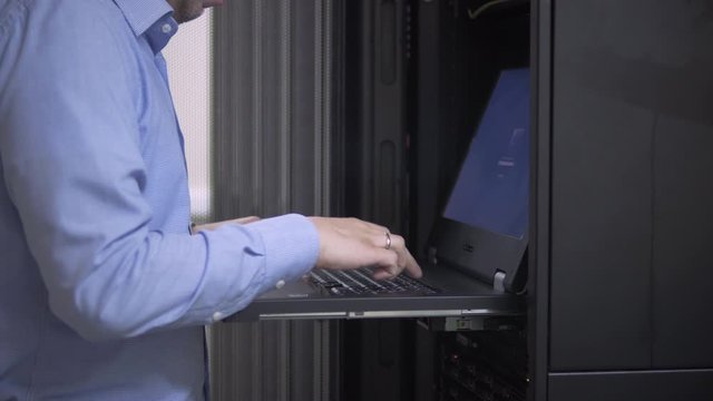 IT engineer checks the server rack