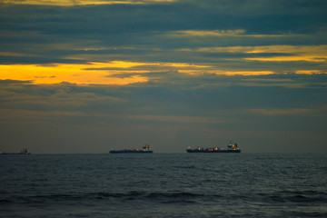 ships in the sea at sunset