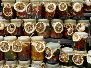 Obraz na płótnie Canvas Honey with nuts in jars decorated with dried lemon. 