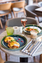 Served table for breakfast. Pancakes with poached egg and smoked salmon.