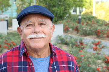 Senior Hispanic man outdoor headshot 