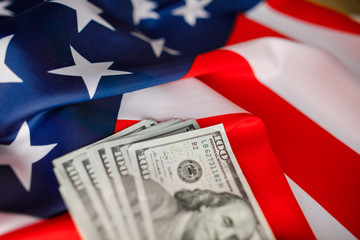 American Dollars Cash Money.  One hundred dollars banknotes close-up on  USA flag background