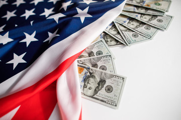 American Dollars Cash Money.  One hundred dollars banknotes close-up on  USA flag background
