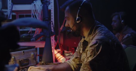 Soldier following car movement on computer