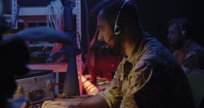 Soldier following car movement on computer