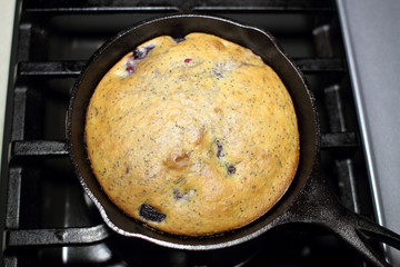 Blackberry and poppy seed cake fresh out of the oven, made in a cast iron 6 inch skillet.