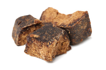 brown cubes of sugar on white background