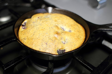 Blackberry and poppy seed cake fresh out of the oven, made in a cast iron 6 inch skillet.