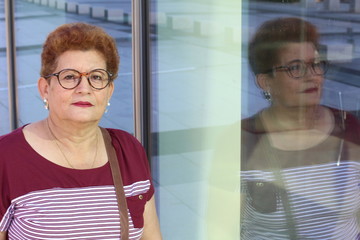 Senior Hispanic woman with her own reflection 