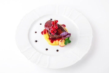 Foie gras with beef minion, mashed asparagus and  artichoke, with berry sauce. Banquet festive dishes. Fine dining restaurant menu. White background.
