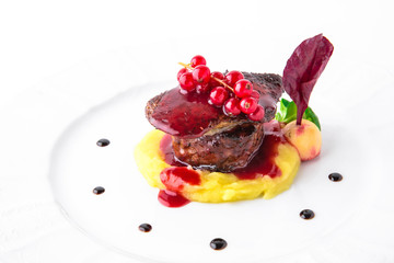 Foie gras with beef minion, mashed asparagus and  artichoke, with berry sauce. Banquet festive dishes. Fine dining restaurant menu. White background.