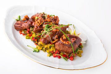 Meat roast with vegetables, nuts in sauce. Rabbit, lamb, or duck baked in the oven. Banquet festive dishes. Gourmet restaurant menu. White background.