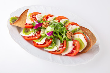 Snack made from fresh vegetables: tomatoes, mozza. Banquet festive dishes. Gourmet restaurant menu. White background.