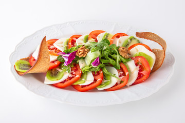 Snack made from fresh vegetables: tomatoes, mozza. Banquet festive dishes. Gourmet restaurant menu. White background.