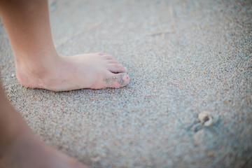 child foot in sand