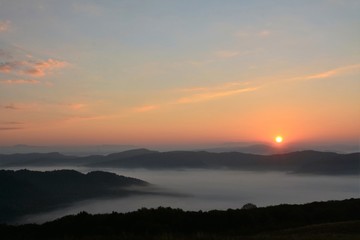 sunrise over the mountains with fog in the valley