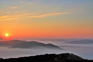 sunrise over mountains with fog in the valley