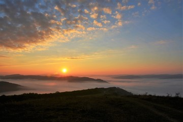 sunrise over the mountains with fog in the valley