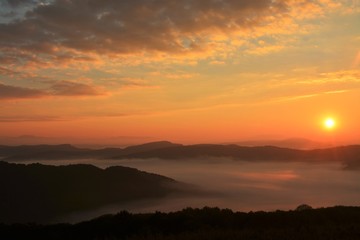 sunrise over mountains with fog in the valley