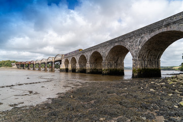 Fototapeta premium Rail Bridge over the River Tavy Devon Dartmoor Plymouth for the Tamar Valley Passenger Railway with Train on the Bridge